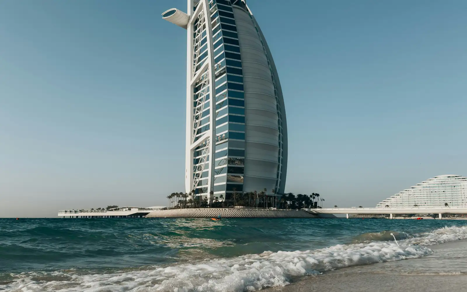 A sail-shaped luxury hotel on the Gulf shore