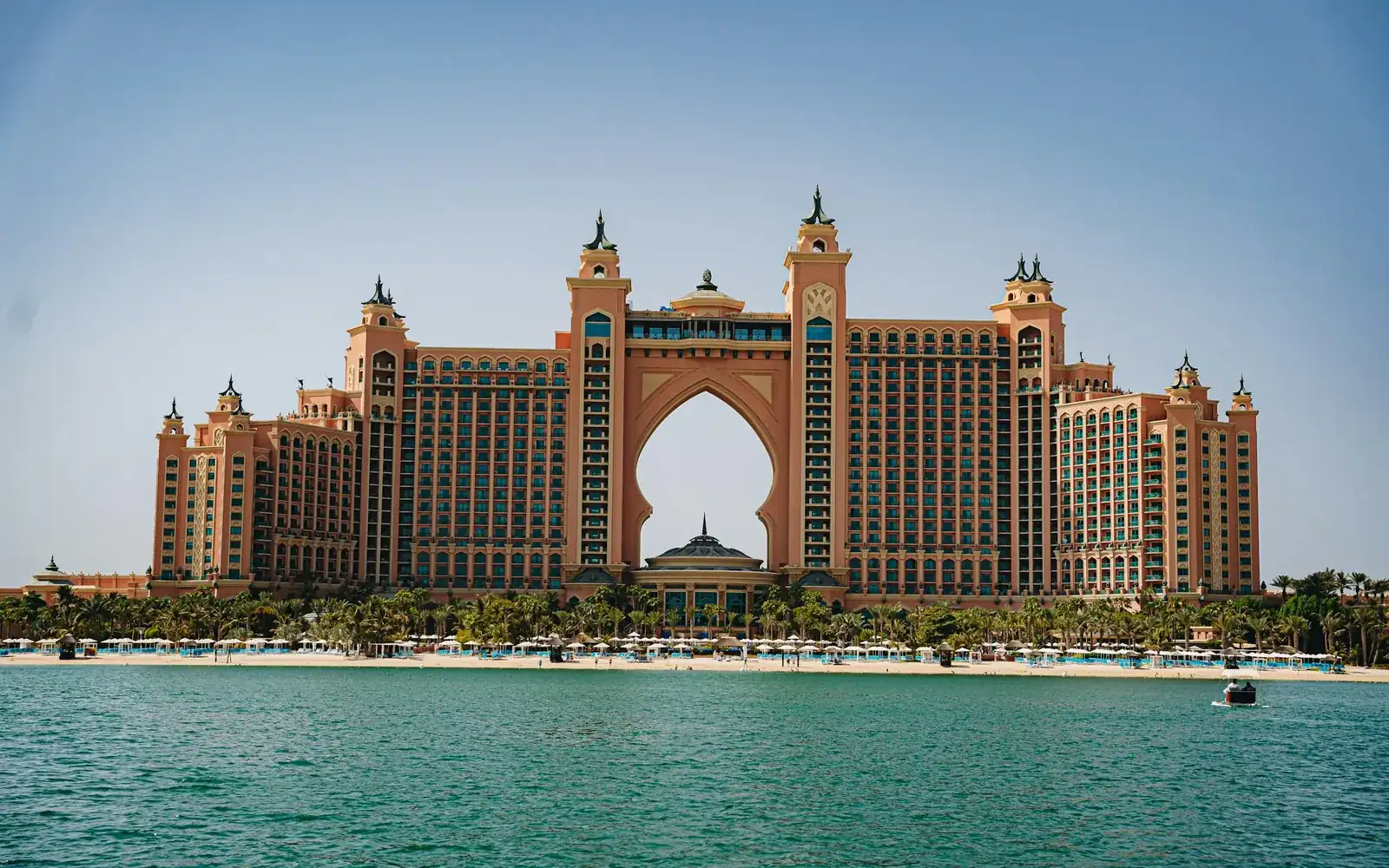 A grand palace hotel rising from the sea at dusk
