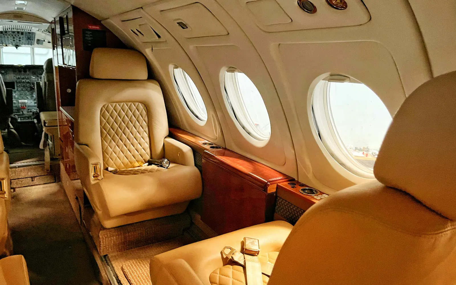 A cream leather private jet cabin